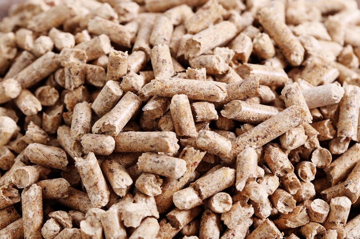 Close-up of wheat bran pellets stacked together, showing their cylindrical shape and texture.